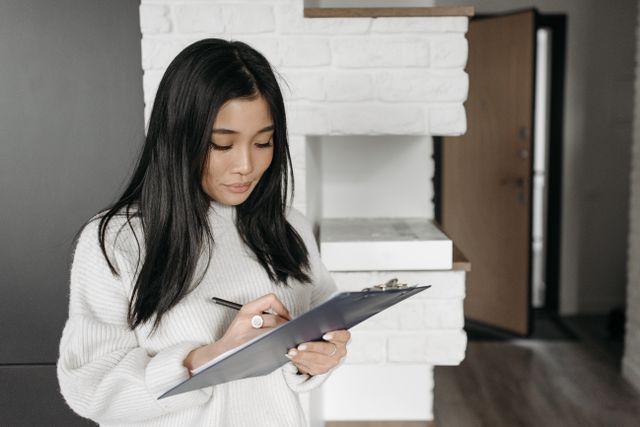 a person taking notes on a clipboard